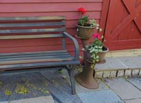 patio bench, flower pots, red shed door