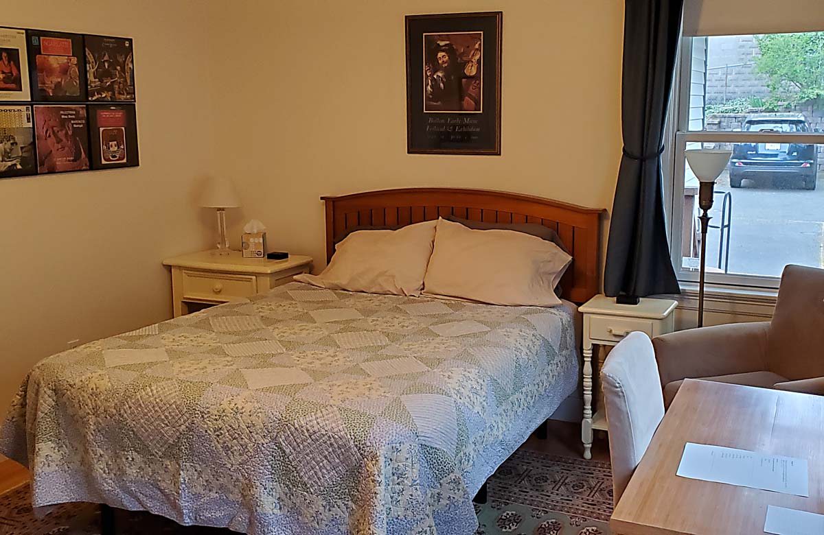 queen bed in room with vinyl album cover decoration