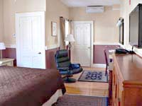 thumbnail: wide angle of very large guest room with king bed